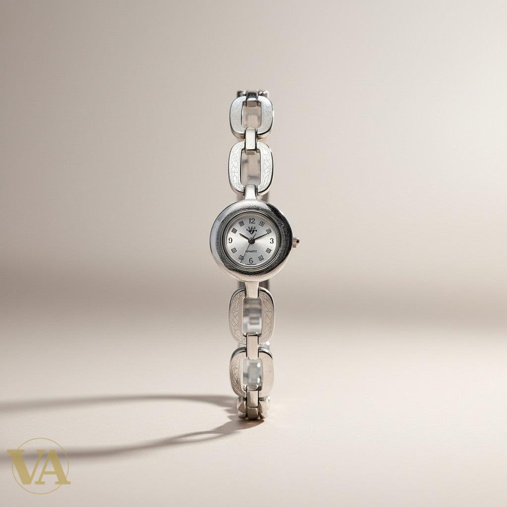 Montre femme Vindicta en argent 925 massif, cadran rond argenté, bracelet maillons sculptés, mouvement quartz.